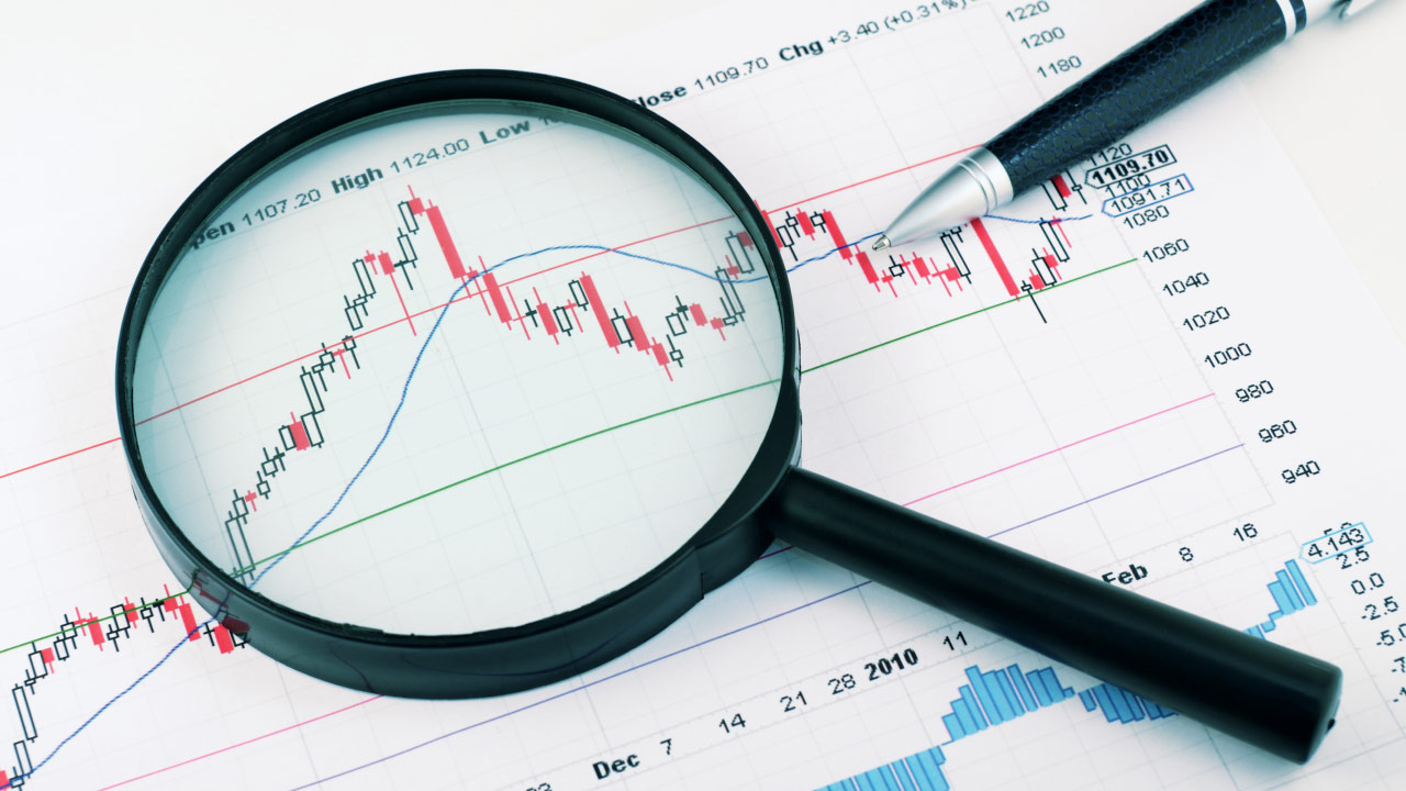 A magnifying glass focusing on a financial chart with candlestick patterns, trend lines, and technical indicators, symbolizing in-depth market analysis using Inner Circle Trader (ICT) concepts.