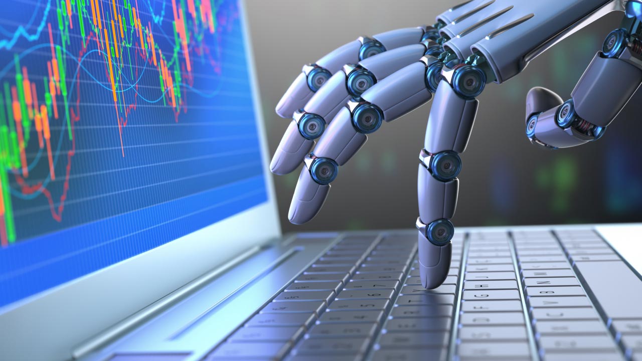 A robotic hand typing on a laptop keyboard with a trading chart displayed on the screen, symbolising the creation of an AI trading bot using ChatGPT.