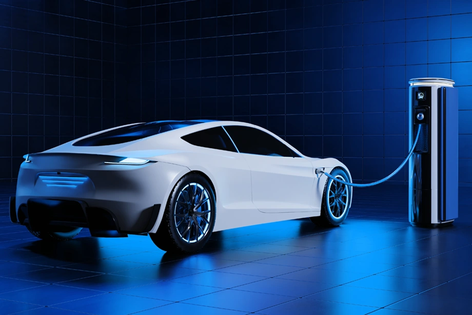 A sleek white electric car charging at a modern EV charging station in a blue-lit environment.